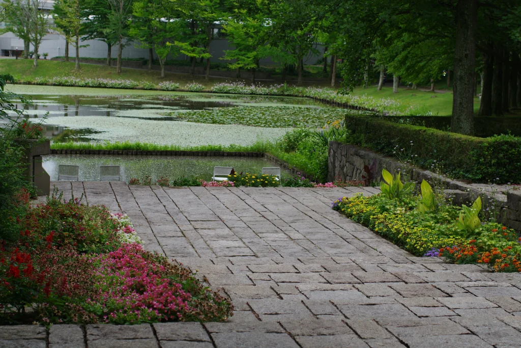 Brick walkway winding through a planted garden