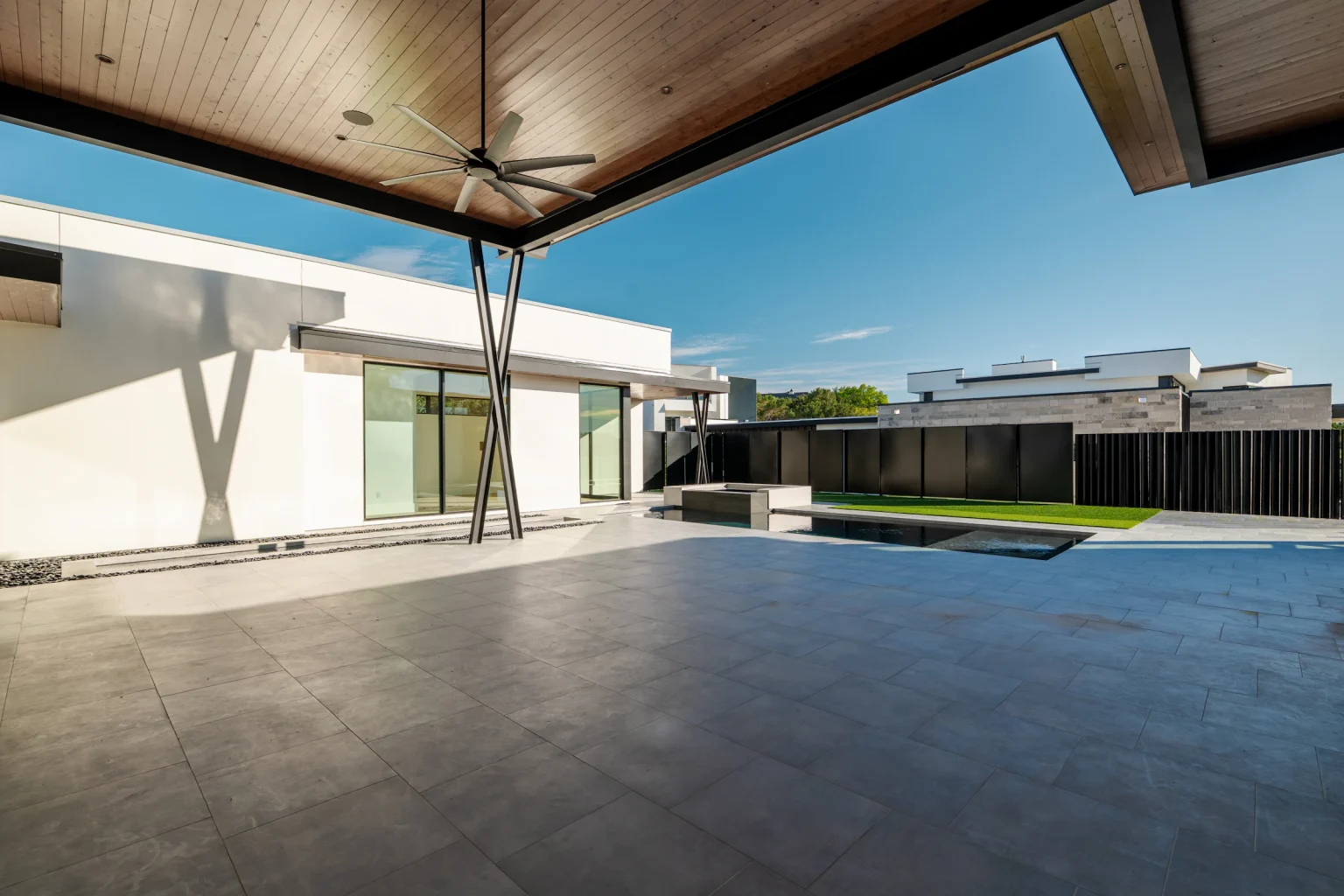 Contemporary home with a covered patio, lounge seating and a pool