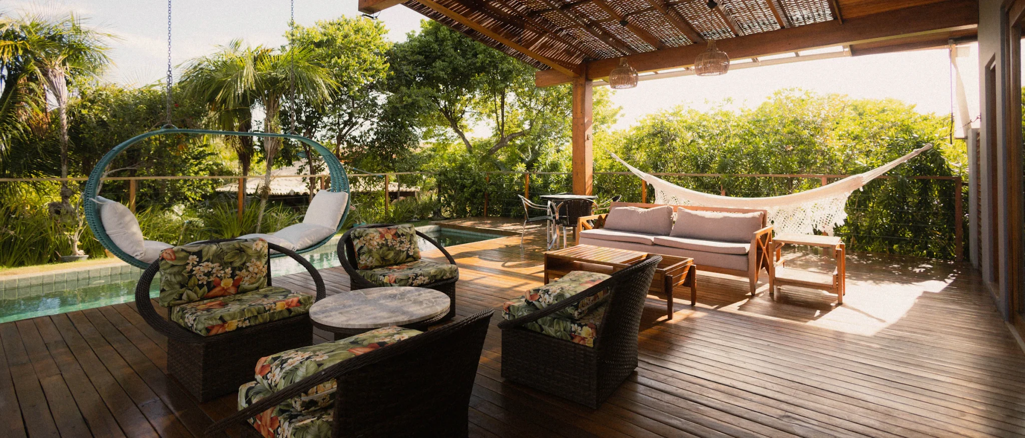 Wide covered patio with lounge seating and a view of the pool