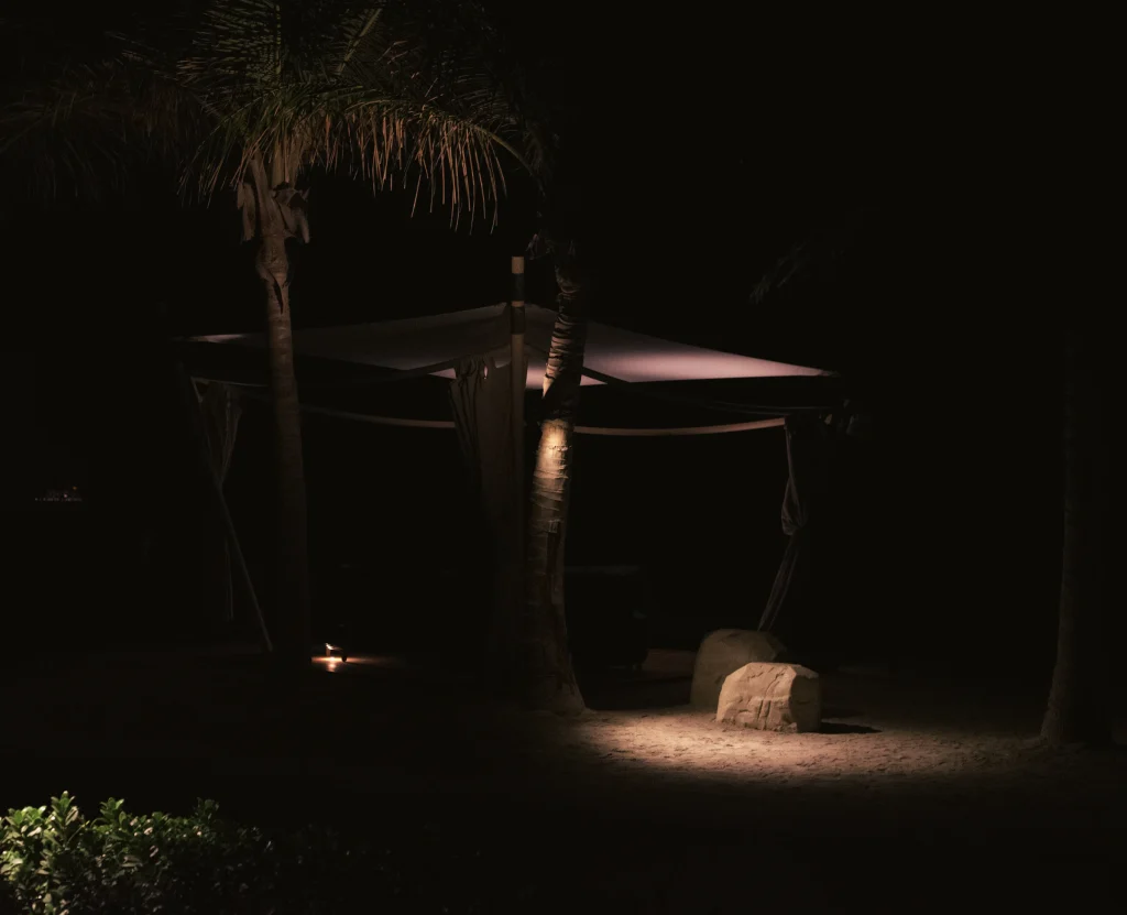 Outdoor pavilion glowing with warm lighting at night