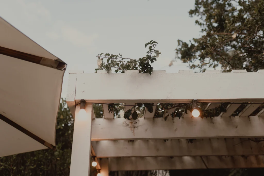 Outdoor pergola with string lights over a seating area