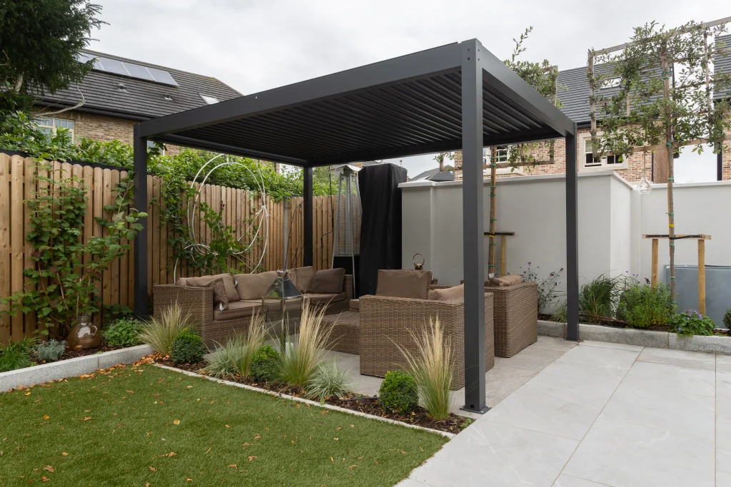 Paved patio lounge with a sofa and table in dappled shade