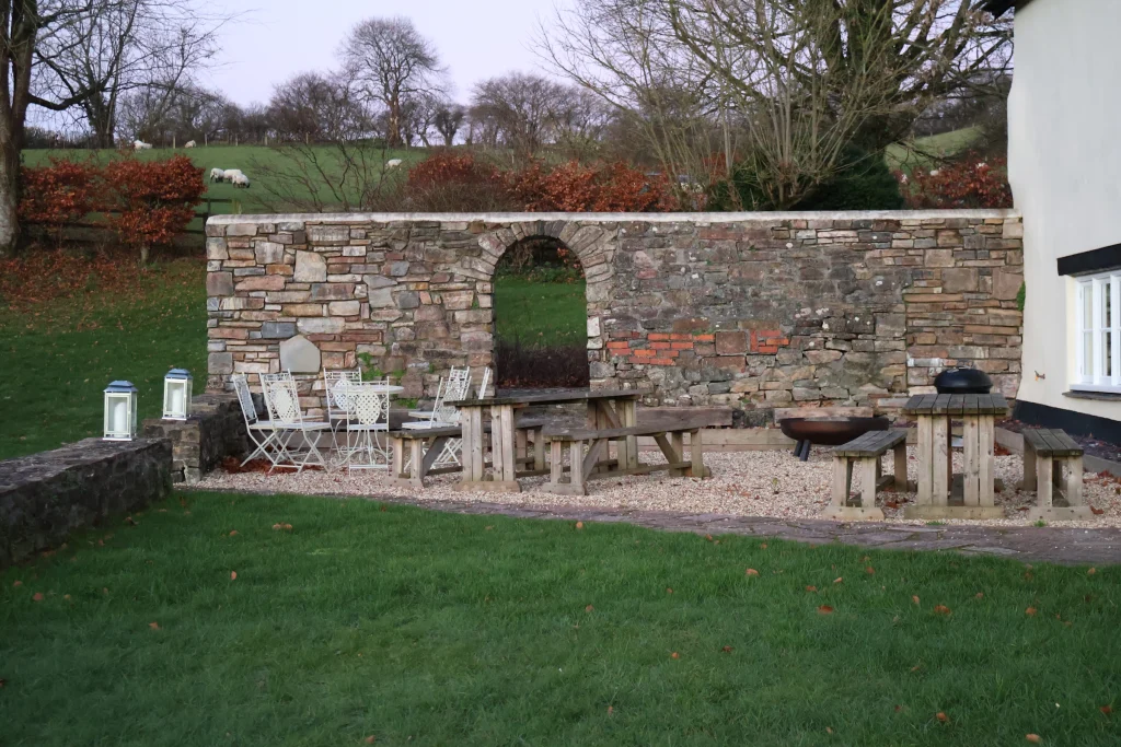 Patio with a stone wall and outdoor furniture