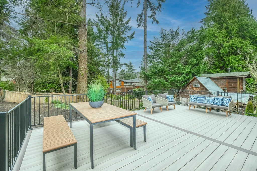 Dining table and chairs on a backyard wood deck